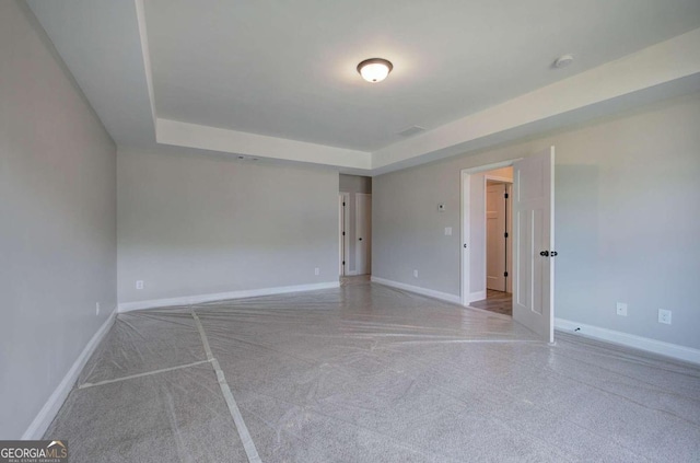 unfurnished room with a tray ceiling