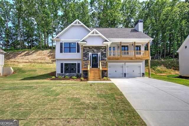 view of front of property featuring a garage, a front lawn, and covered porch