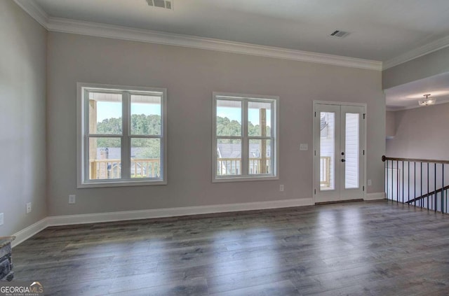 empty room featuring ornamental molding, dark wood-type flooring, and plenty of natural light