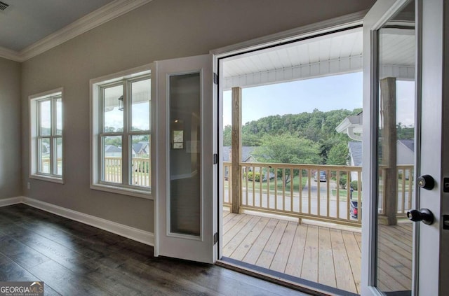 entryway featuring ornamental molding and dark hardwood / wood-style flooring