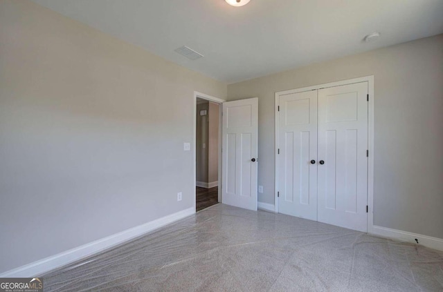 unfurnished bedroom featuring a closet and carpet