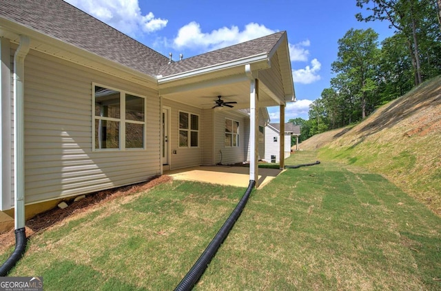 view of yard featuring a patio area and ceiling fan