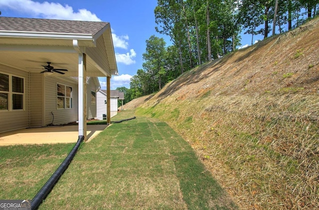 view of yard featuring ceiling fan and a patio area