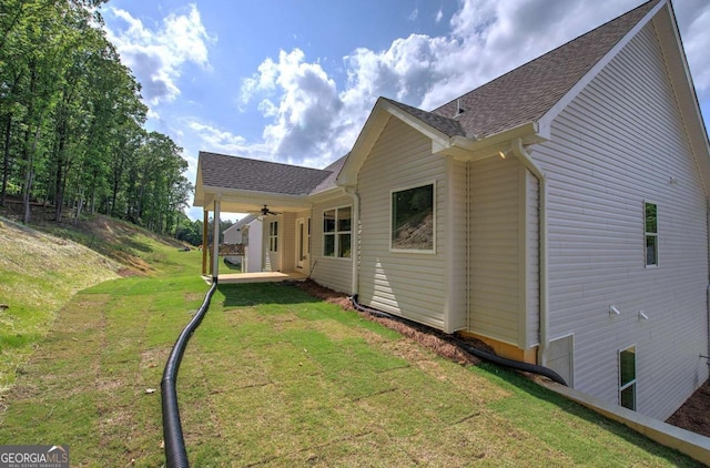 back of property featuring a patio and a yard