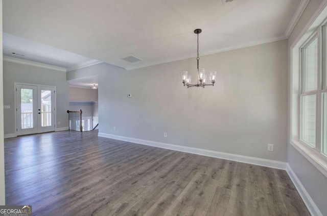 spare room with a notable chandelier, french doors, crown molding, and dark hardwood / wood-style flooring