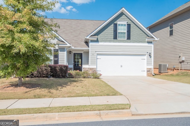 craftsman house featuring a front lawn, a garage, and central air condition unit