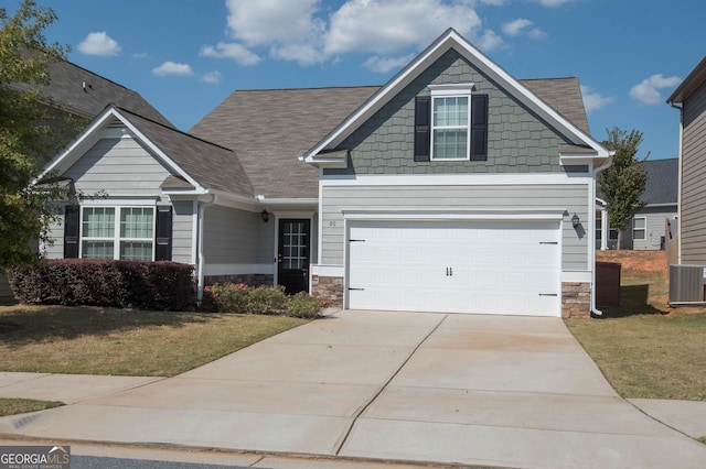 craftsman-style home with central AC, a garage, and a front yard