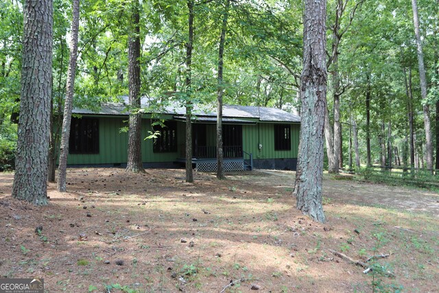 view of front of house with a view of trees