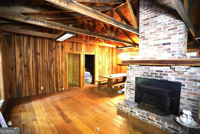 350 County Road 700, Cedar Bluff, AL 35959 - unfurnished living room featuring wood walls, a fireplace, lofted ceiling with beams, and wood-type flooring