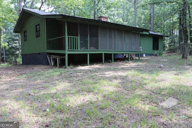 back of property featuring a sunroom