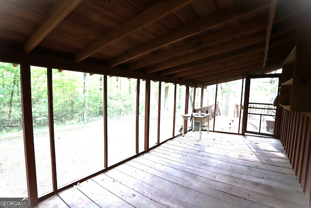 unfurnished sunroom with beam ceiling and wood ceiling