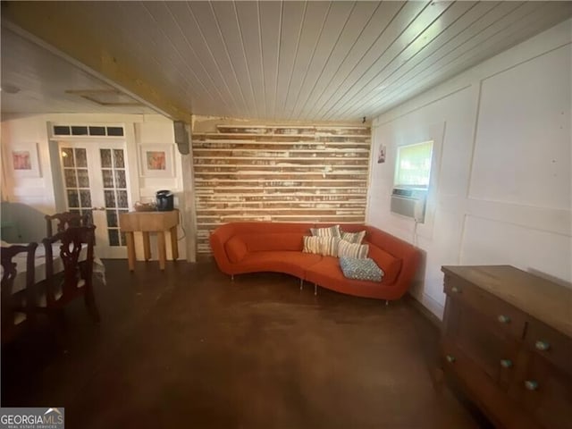 sitting room with french doors and concrete flooring