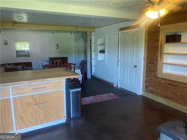 kitchen featuring ceiling fan, light brown cabinets, and a textured ceiling