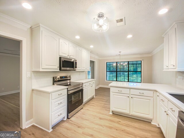 kitchen featuring crown molding, light hardwood / wood-style flooring, and stainless steel appliances