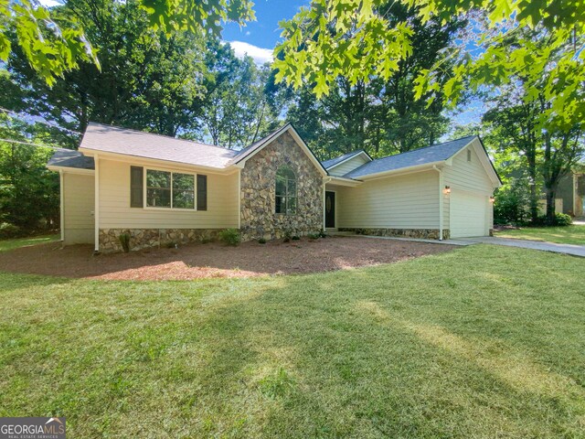 single story home with a garage and a front yard