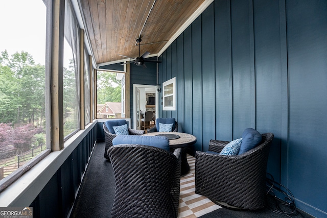 sunroom with wooden ceiling and ceiling fan