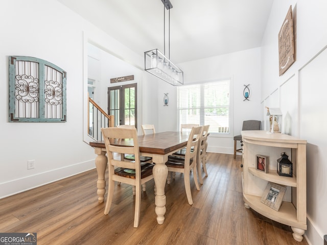 dining area with wood-type flooring and french doors