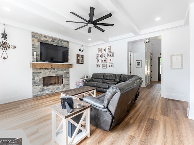 living room with a fireplace, hardwood / wood-style floors, ceiling fan, and beam ceiling