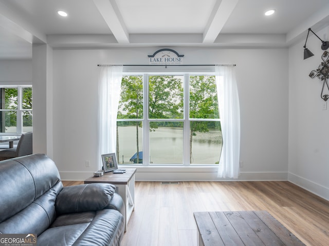 living room with beamed ceiling and wood-type flooring