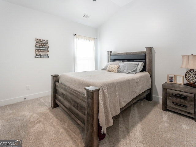 carpeted bedroom with lofted ceiling