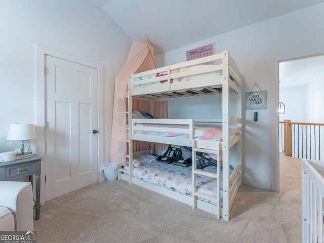 bedroom featuring light carpet and vaulted ceiling