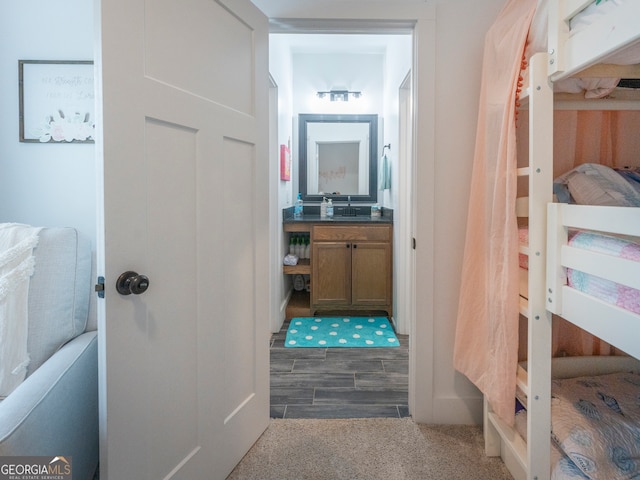 hallway with carpet and sink