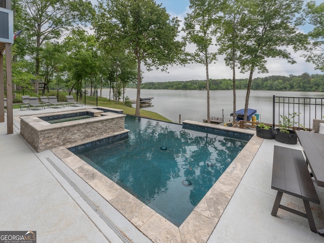 view of pool featuring a patio and an in ground hot tub