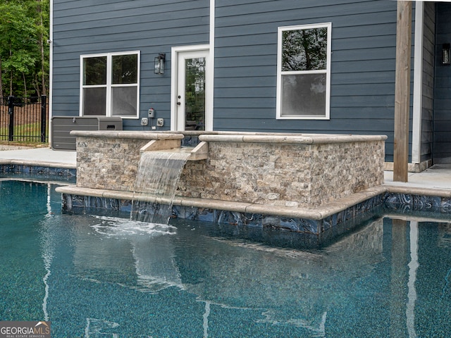 view of swimming pool featuring pool water feature