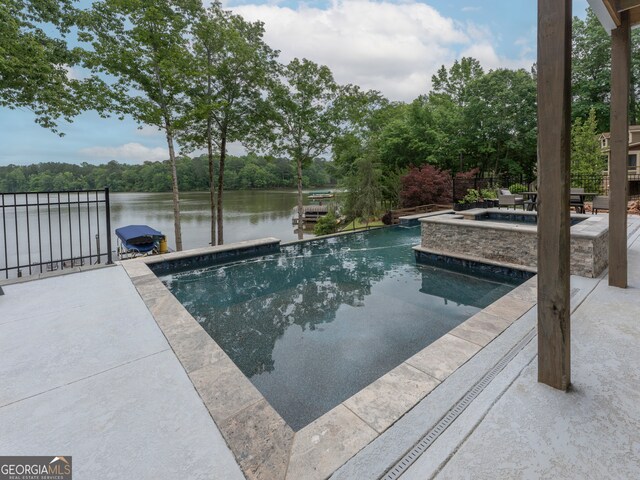 view of pool with an in ground hot tub