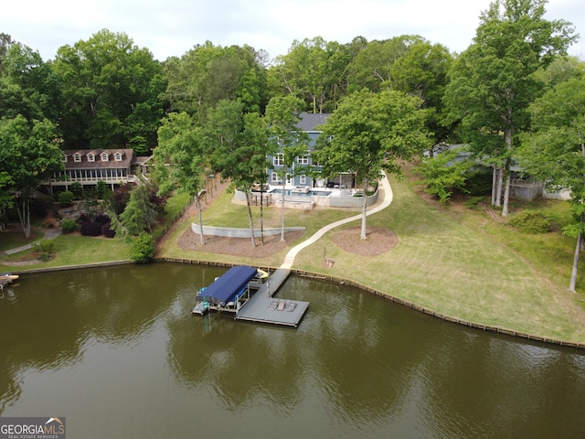 dock area with a lawn and a water view