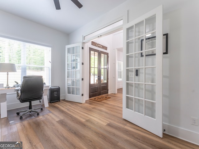 office space featuring french doors, plenty of natural light, ceiling fan, and hardwood / wood-style floors