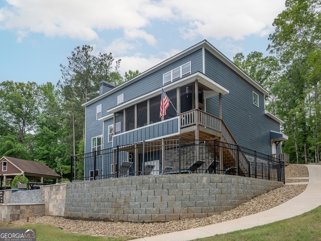 rear view of property with a sunroom