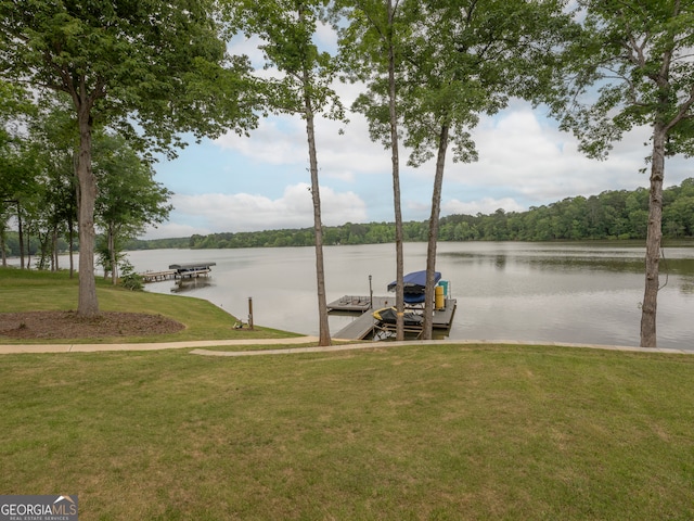 view of dock featuring a water view and a lawn