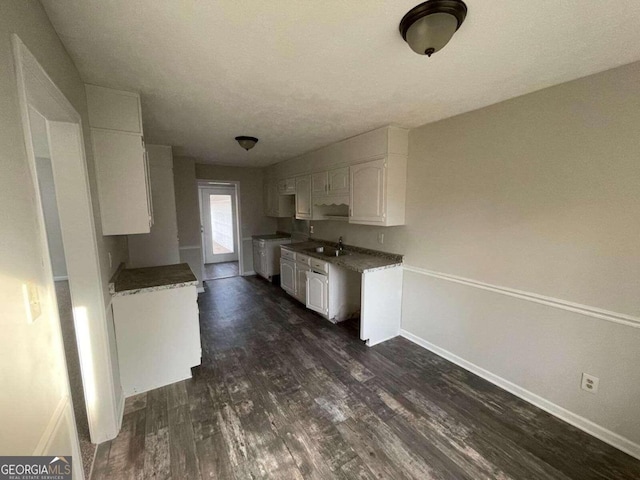 kitchen featuring sink, dark hardwood / wood-style flooring, and white cabinetry