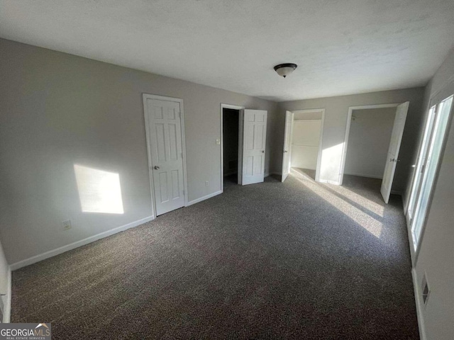 unfurnished bedroom featuring dark carpet