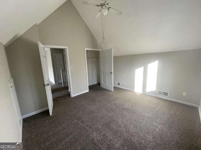 unfurnished bedroom featuring high vaulted ceiling, ceiling fan, and dark carpet