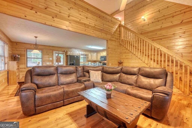 living room featuring wood walls and light hardwood / wood-style flooring