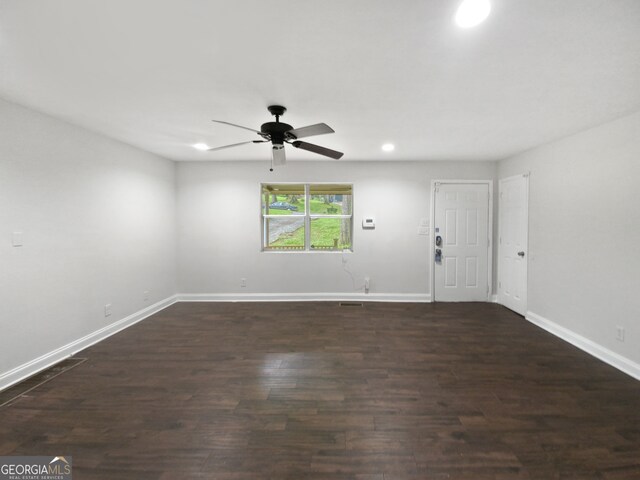 spare room featuring dark hardwood / wood-style floors and ceiling fan