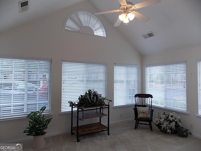 sitting room with high vaulted ceiling, carpet flooring, and ceiling fan