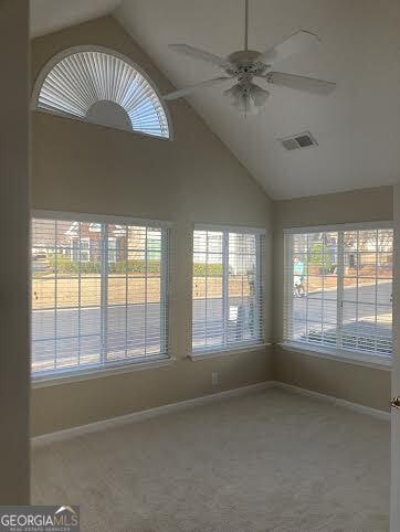 unfurnished sunroom featuring lofted ceiling and ceiling fan