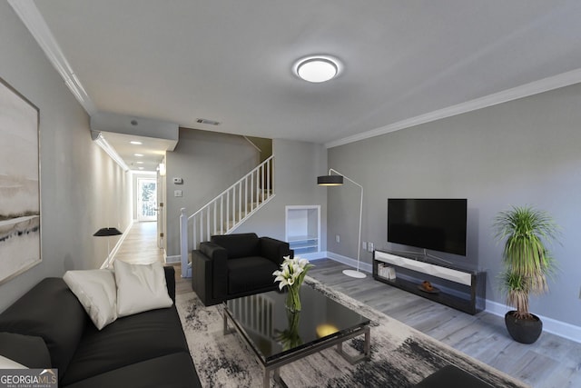 living room featuring ornamental molding and wood-type flooring