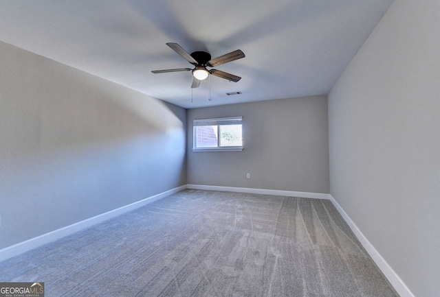 unfurnished room featuring ceiling fan and carpet