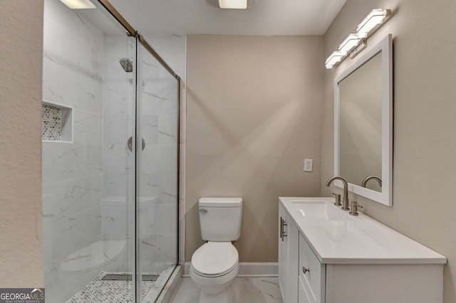 bathroom featuring a shower with door, toilet, and vanity