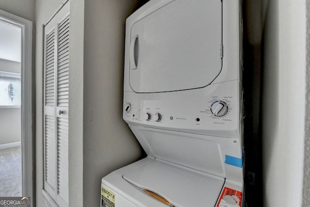 laundry room featuring stacked washer and clothes dryer