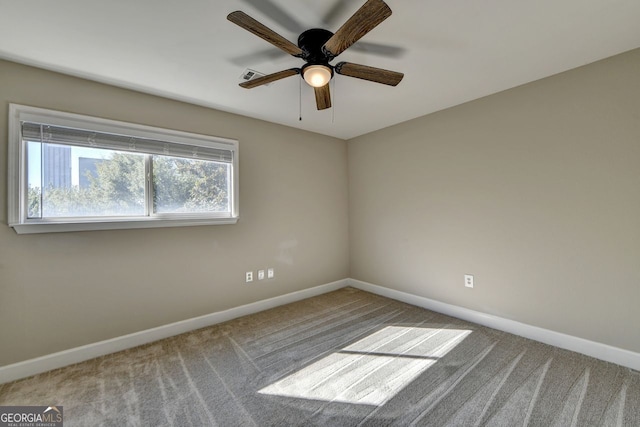 unfurnished room featuring ceiling fan, a wealth of natural light, and carpet flooring