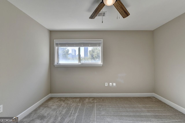 carpeted empty room featuring ceiling fan