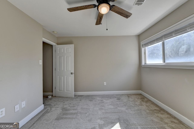 carpeted empty room with ceiling fan