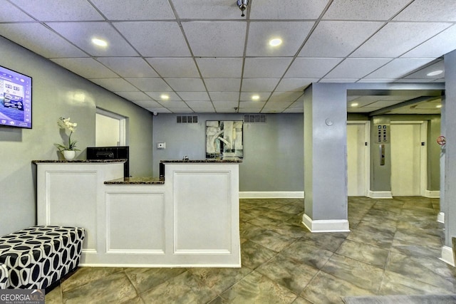 interior space featuring white cabinetry and dark stone counters