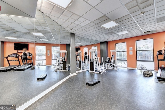 workout area with a wealth of natural light and a drop ceiling