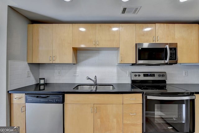 kitchen featuring decorative backsplash, sink, light brown cabinets, and stainless steel appliances